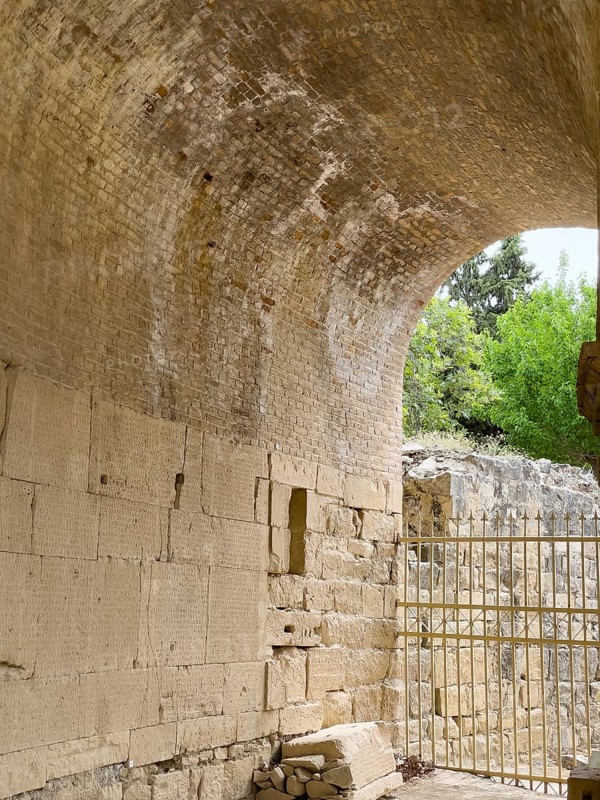 Wall of archway behind amphitheatre carved written chiselled laws City law of Gortys carved in stone Gortyn law book Large inscription, written in Doric dialect alternately from left to right and right to left, oldest discovered legal text in Europe, Gortyna, Crete, Greece, Europe