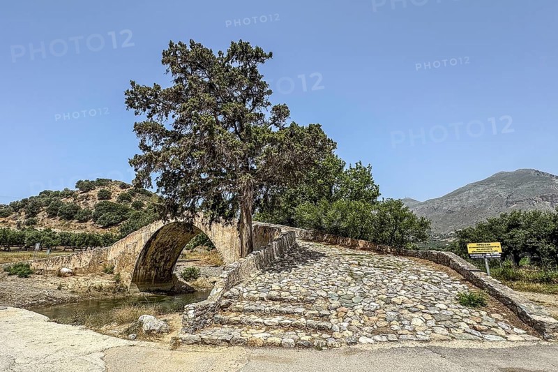 View of stairway with coarse cobblestones of historic classical arched stone bridge in Venetian architectural style Venetian Great Old Bridge 19th century stone bridge built in 1850 in Ottoman times over the middle reaches of river Megalopotamos at Preveli, Agios Vasilios, Crete, Greece, Europe