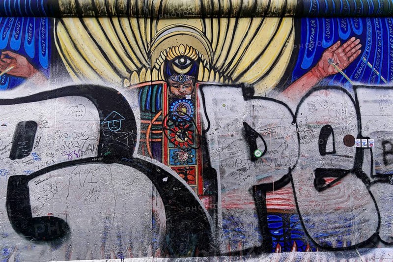 Mural showing an angel with wings, overlaid with graffiti and scribbles on an urban wall, mural, East Side Gallery, Mauergalerie, Berlin, Germany, Europe