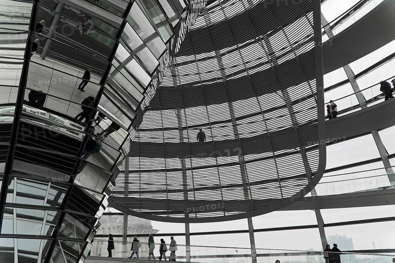 The dome of the Reichstag in Berlin. The architect Sir Norman Foster designed the steel and glass structure. Berlin, Berlin, Germany, Europe, people walk in a modern glass construction with reflective surfaces and a futuristic atmosphere, The dome of the Berlin Reichstag. Berlin, Europe