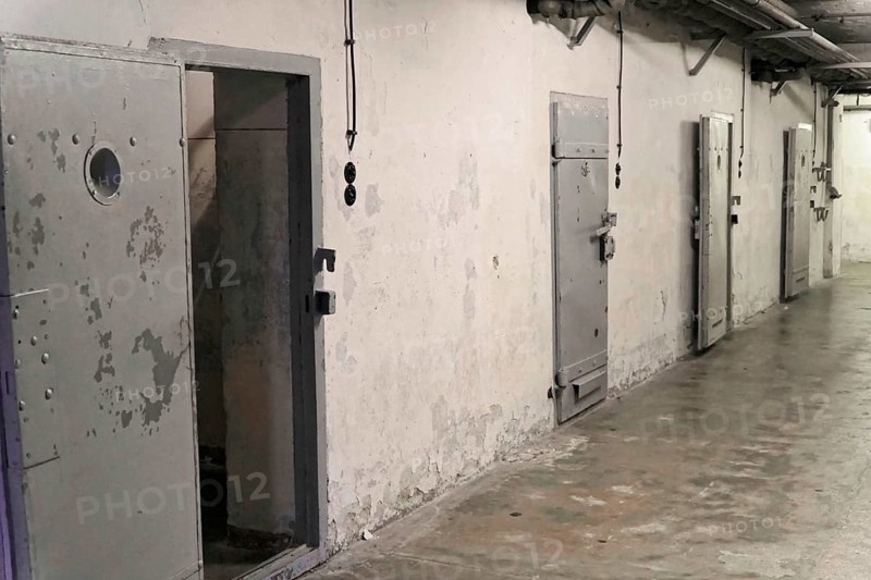 Prison corridor with several robust metal cell doors and light switches. Gloomy, deserted atmosphere, Berlin-Hohenschoenhausen Memorial, former headquarters, Stasi remand centre, Berlin, Germany, Europe