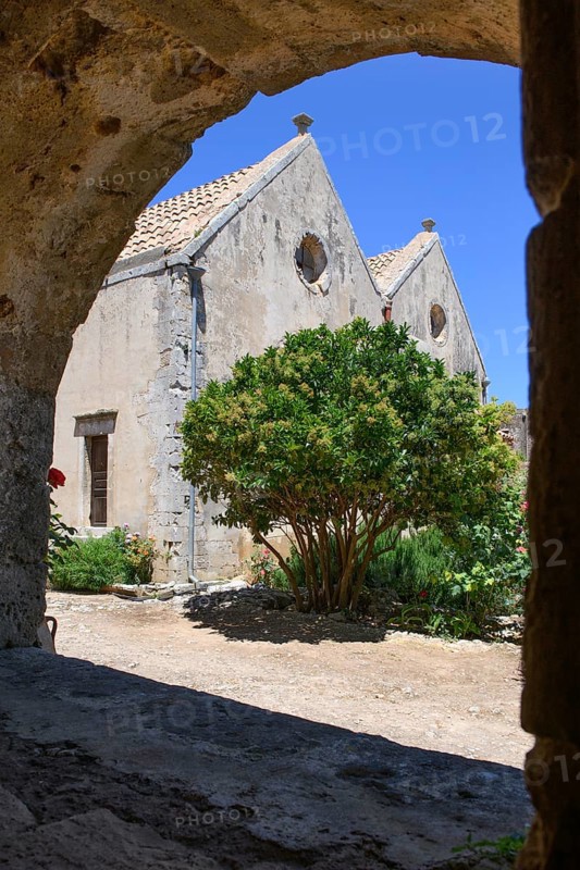 View through archway to rear wall of two-nave church building Church of Arkadi Monastery UNESCO World Heritage Site Orthodox Monastery of Moni Arkadi Arkadi Monastery from the early Middle Ages, important national monument National Shrine on the island of Crete, Arkadi, Armnatos, Crete, Greece, Europe