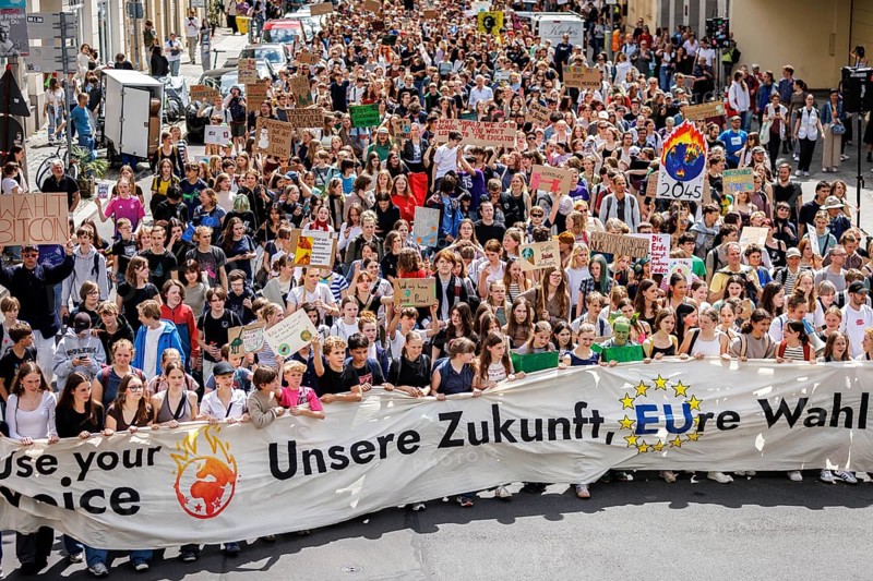 Demonstrators with signs at Fridays for Future, taken during the climate strike for the EU elections in Berlin, 31/05/2024