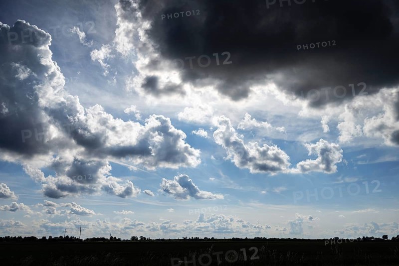 A dark cumulus cloud looms menacingly over the landscape