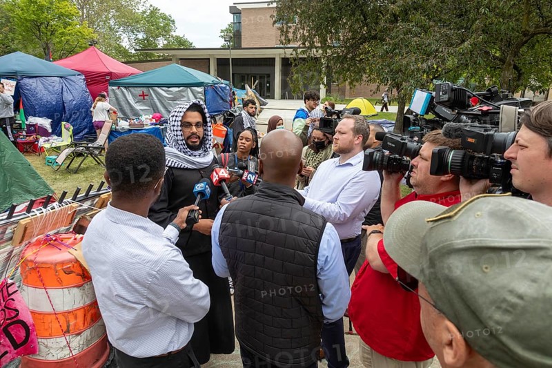 Detroit, Michigan USA, 28 May 2024, A tent encampment set up by students at the Wayne State University in solidarity with the victims of Israeli bombing in Gaza. The university responded by canceling classes 'until further notice.' Ali Hassan, president of the WSU Muslim Coalition, speaks to journalists at the camp