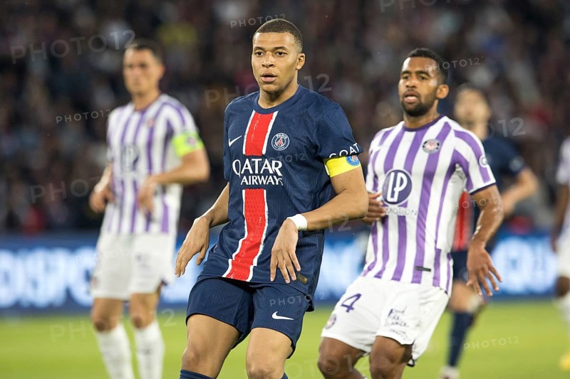 Football match, captain Kylian MBAPPE' Paris St. Germain left focussed looking forward together with opponent Cristian CASSERES FC Toulouse, Parc des Princes football stadium, Paris, France, Europe