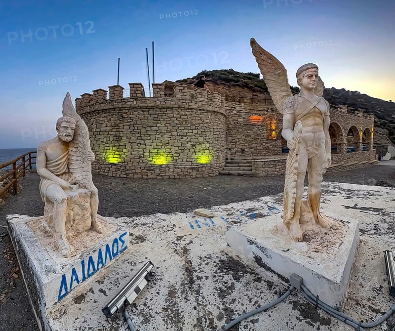Photo at dusk evening mood of illuminated monument to Daedalus and Icarus on cliff of flight for flight from Crete of figures statues heroes legendary figures of Greek mythology, left in the background Libyan Sea Mediterranean, Agia Galini, Crete, Greece, Europe