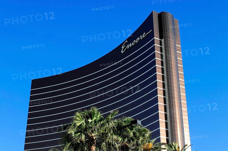 Las Vegas, Nevada, USA, North America, High-rise building of the Encore Hotel in Las Vegas, surrounded by palm trees, in front of a clear blue sky, showing modern architecture, Las Vegas Strip, North America