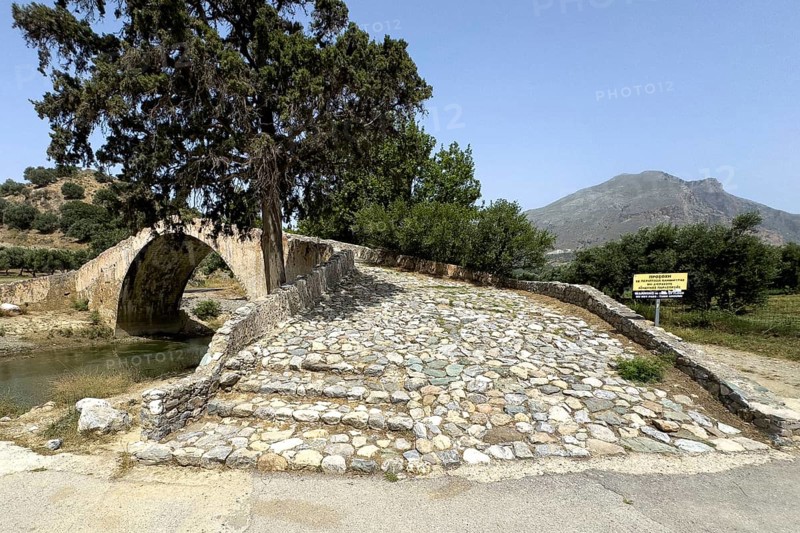 View of stairway with coarse cobblestones of historic classical arched stone bridge in Venetian architectural style Venetian Great Old Bridge 19th century stone bridge built in 1850 in Ottoman times over the middle reaches of river Megalopotamos at Preveli, Agios Vasilios, Crete, Greece, Europe