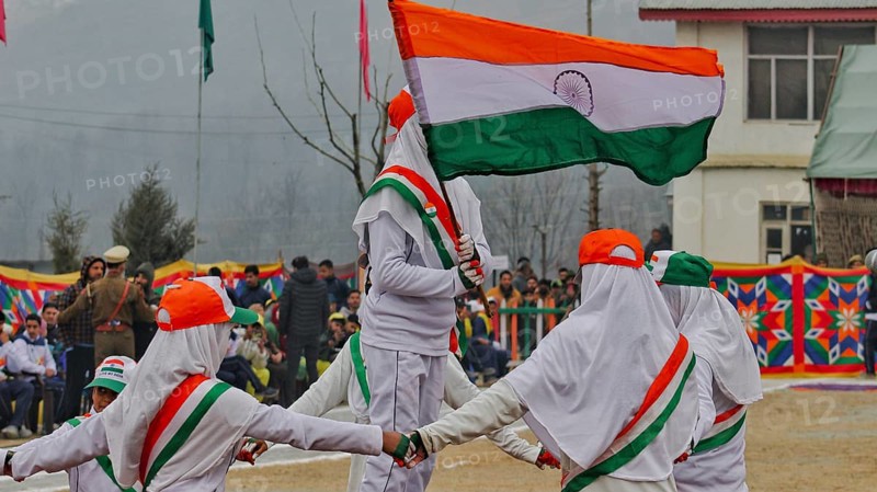 Children in white uniforms holding the Indian flag while participating in a parade filled with national pride, Srinagar, Jammu and Kashmir, India, Asia