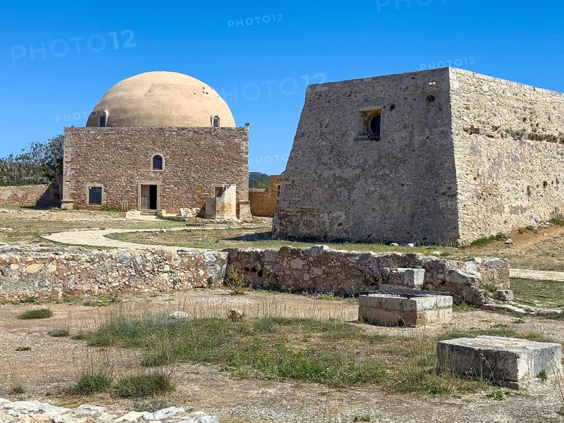 To the right of domed building ruins of former Sultan Ibrahim Mosque part of historic residence of Venetian governor rector in fortress ruins of fortress Fortetza Fortezza of Rethymno built by Republic of Venice in 16th century in northwest of old town of Rethymno on rocky hill Paleokastro on north coast of island Crete, Rethymno, Crete, Greece, Europe