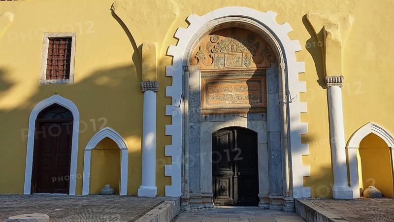 Ottoman Library, Yellow historical facade of a building with an ornate entrance arch, inscriptions and evening light, Rhodes Old Town, Rhodes Town, Rhodes, Dodecanese, Greek Islands, Greece, Europe
