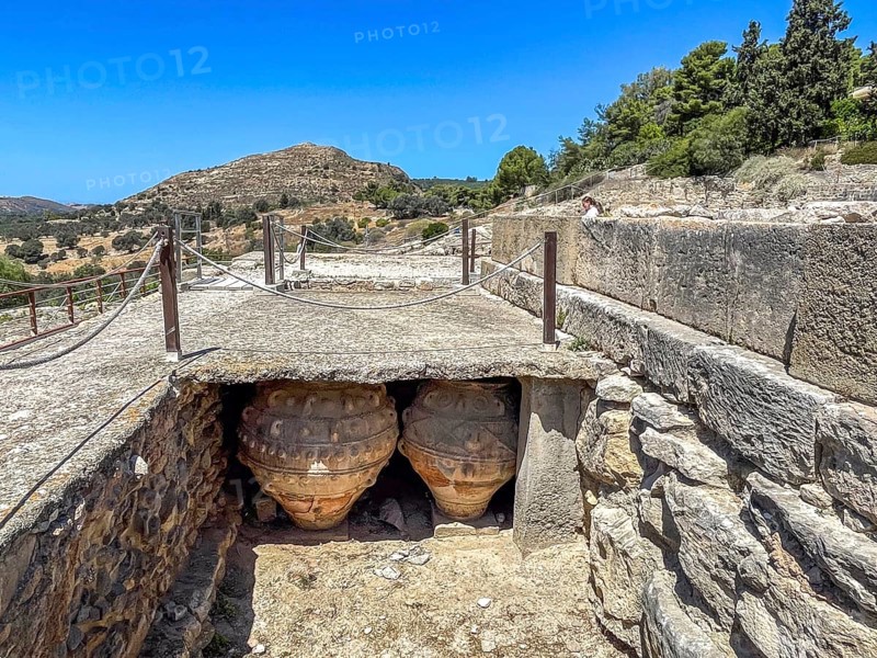 View into historical storeroom below present floor level with two large decorated clay vessels Pithoi in ancient magazine building with supplies in excavation site on hill of Phaistos palace of Minoan culture pre-Greek ancient Greek people Minoans in antiquity, Festos, Crete, Greece, Europe