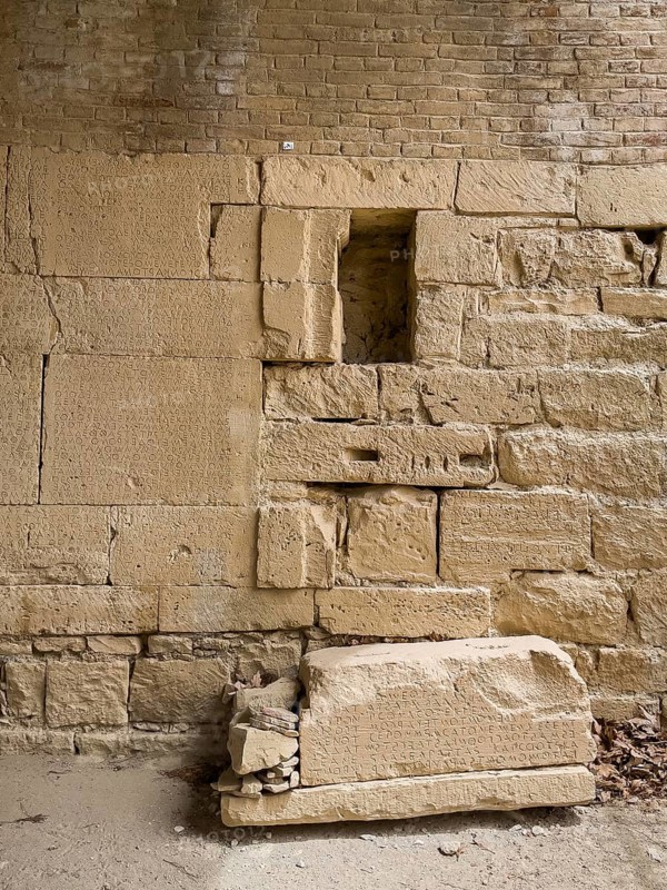 View of sandstone blocks at the bottom of the floor on the left of the wall Sandstone blocks with written chiselled laws carved into the wall of the archway behind the amphitheatre City law of Gortys carved in stone Gortyn law book Large inscription, written in Doric dialect alternately from left to right and right to left, oldest discovered legal text in Europe, Gortyna, Crete, Greece, Europe