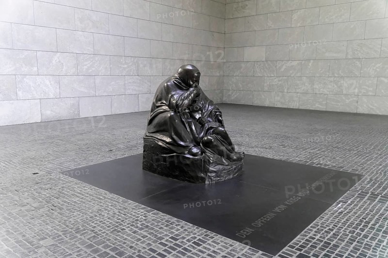 Pieta by Kaethe Kollwitz in the Schinkelbau Neue Wache unter den Linden in Berlin, Berlin, Germany, Europe, Sad sculpture of a mother with her child displayed on a grey square, Europe