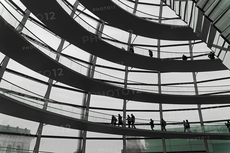 The dome of the Reichstag in Berlin. The architect Sir Norman Foster designed the steel and glass structure. Berlin, Berlin, Germany, Europe, Various people move along winding staircases in a modern glass construction, The dome of the Berlin Reichstag. Berlin, Europe