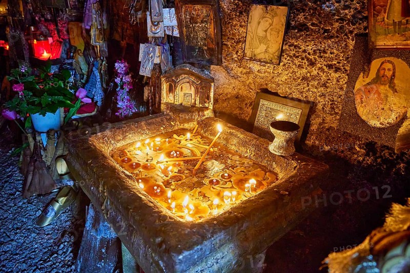 Rock Chapel, Archangel Michael Panormitits, Illuminated altar with burning candles in a cave, surrounded by icons and religious decorations, Old Town of Rhodes, Rhodes Town, Rhodes, Dodecanese, Greek Islands, Greece, Europe