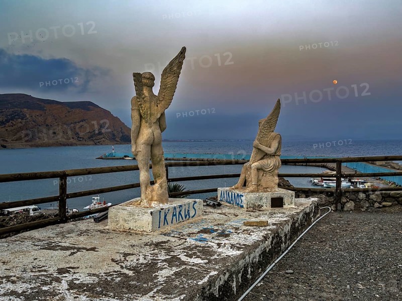 Photo taken at dusk evening mood of monument to Daedalus and Icarus on cliff of flight for flight from Crete of figures statues legendary figures of Greek mythology, in the background Libyan Sea Mediterranean, Agia Galini, Crete, Greece, Europe
