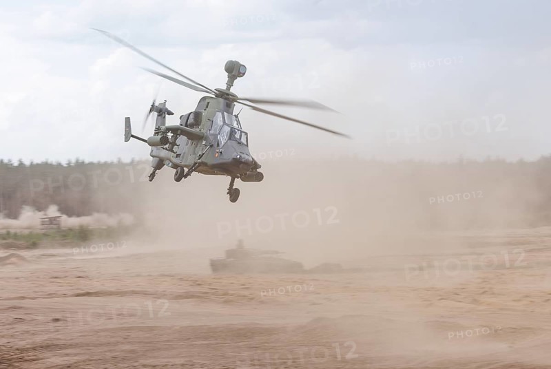 A Cougar infantry fighting vehicle and two Tiger combat helicopters, photographed during the NATO large-scale manoeuvre Steadfast Defender and the German part of the exercise, Quadriga 2024, in Pabrade, 29.05.2024