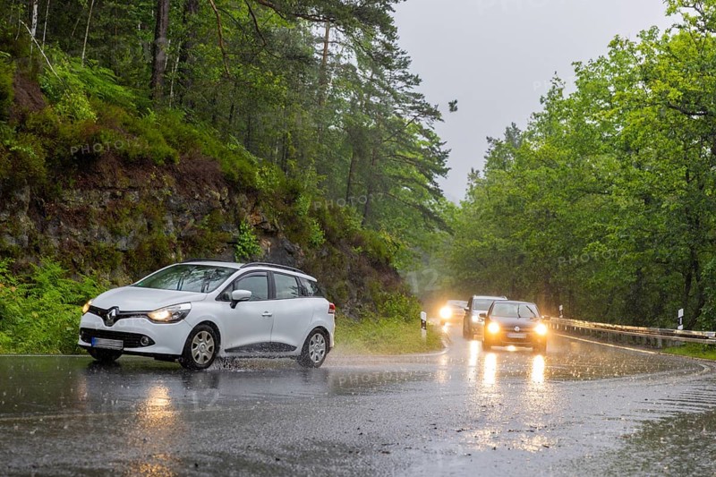 Car traffic during a thunderstorm in the Saxon Switzerland, cloudburst, Hohnstein, Saxony, Germany, Europe