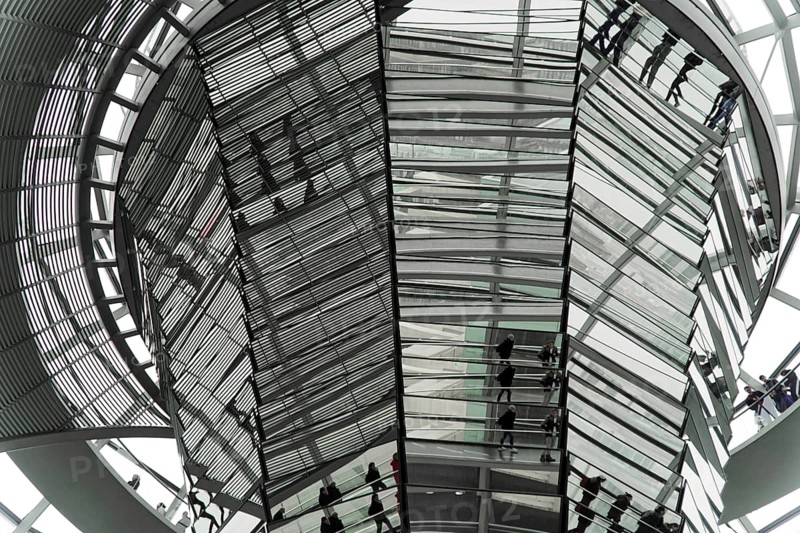 The dome of the Reichstag in Berlin. The architect Sir Norman Foster designed the steel and glass structure. Berlin, Berlin, Germany, Europe, View of people in a complex glass construction dominated by reflective and geometric shapes, The dome of the Berlin Reichstag. Berlin, Europe