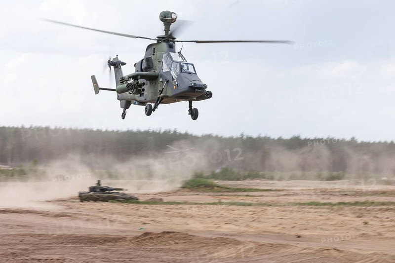 A Cougar infantry fighting vehicle and two Tiger combat helicopters, photographed during the NATO large-scale manoeuvre Steadfast Defender and the German part of the exercise, Quadriga 2024, in Pabrade, 29.05.2024