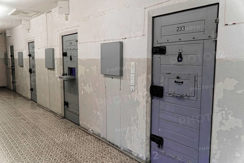Corridor in a prison with worn grey metal doors and security area, Berlin-Hohenschoenhausen Memorial, former headquarters, Stasi remand prison, Berlin, Germany, Europe
