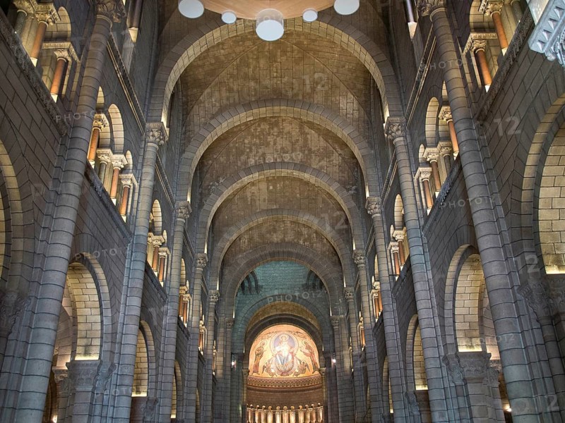 Impressive church interior with stone arches, vaults and ceiling mosaic, Monte Carlo, Monaco, Europe