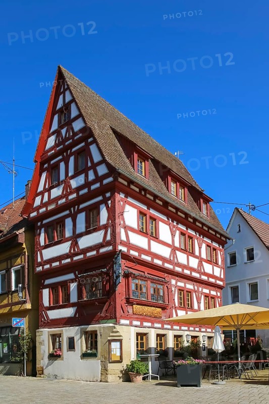 Ratsstueble restaurant, traditional restaurant, pub, half-timbered house, three-storey half-timbered building with solid ground floor, gabled roof, ornamental half-timbering, bay windows, sunshades, Boennigheim, Ludwigsburg district, Baden-Wuerttemberg, Germany, Europe