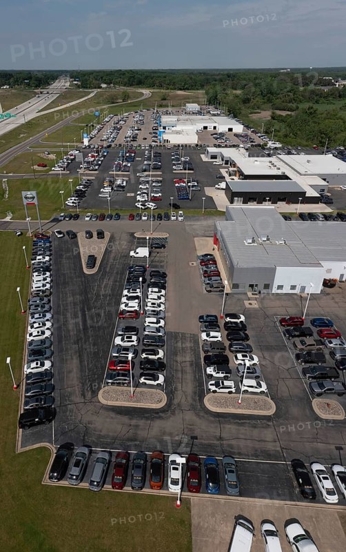 Jackson, Michigan, New car dealers along Interstate 94. From bottom: Nissan, Chrysler, Honda, and Chevrolet vehicles on sale