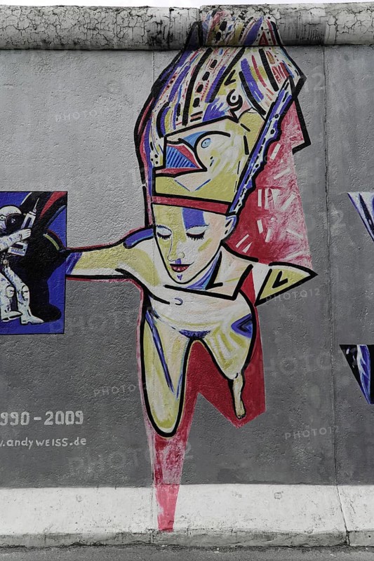 Graffiti on the Berlin Wall at the East Side Gallery, Berlin, Germany, Europe, Colourful graffiti artwork on the Berlin Wall showing an abstract human figure, Europe