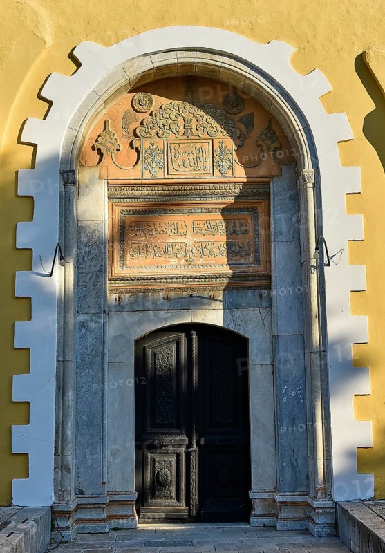 Ottoman Library, Historic entrance door with richly decorated archway and inscriptions in a yellow building in the shade, Rhodes Old Town, Rhodes Town, Rhodes, Dodecanese, Greek Islands, Greece, Europe