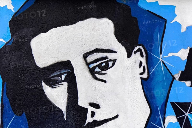 Cubist black and white portrait of a face with blue background on a wall, mural, East Side Gallery, Mauergalerie, Berlin, Germany, Europe