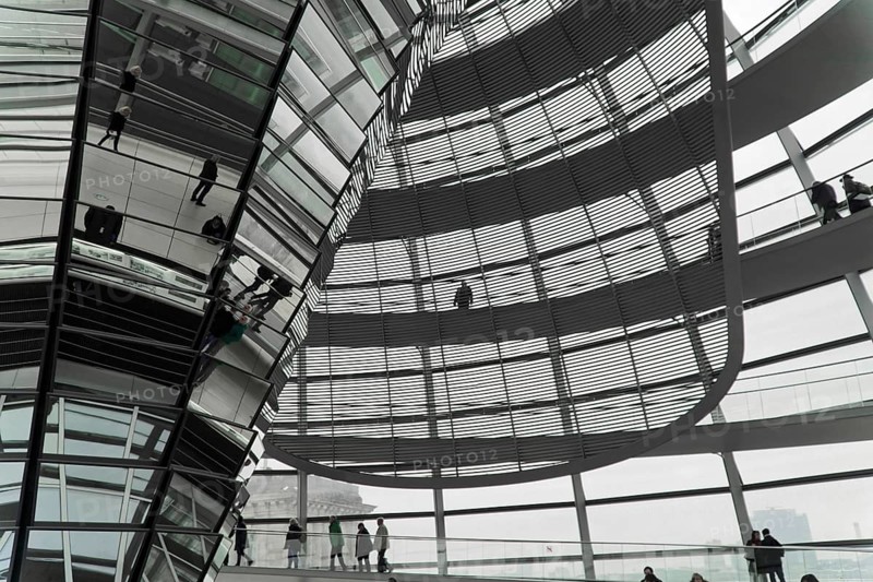 The dome of the Reichstag in Berlin. The architect Sir Norman Foster designed the steel and glass structure. Berlin, Berlin, Germany, Europe, People walk through a contemporary glass construction with a futuristic atmosphere and reflective surfaces, The dome of the Berlin Reichstag. Berlin, Europe