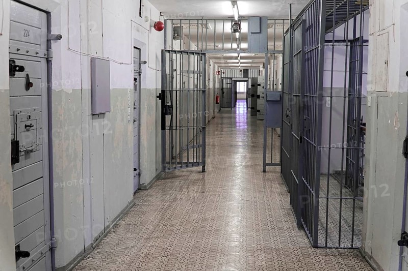Long corridor of a prison with metal and barred doors and worn walls, Berlin-Hohenschoenhausen Memorial, former headquarters, Stasi remand centre, Berlin, Germany, Europe