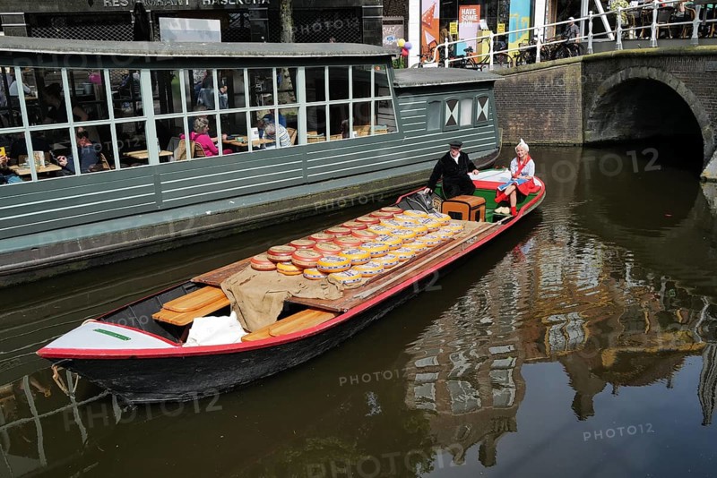 A load of Beemster cheese being transported on a canal in the city centre on market day. Alkmaar, The Netherlands, Europe