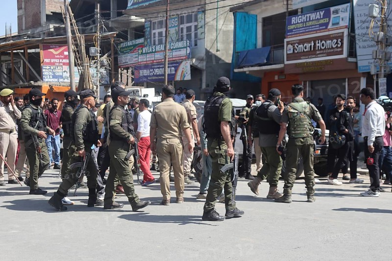 Police personnel managing a crowd in an urban street, ensuring security and order, Jammu and Kashmir, India, Asia