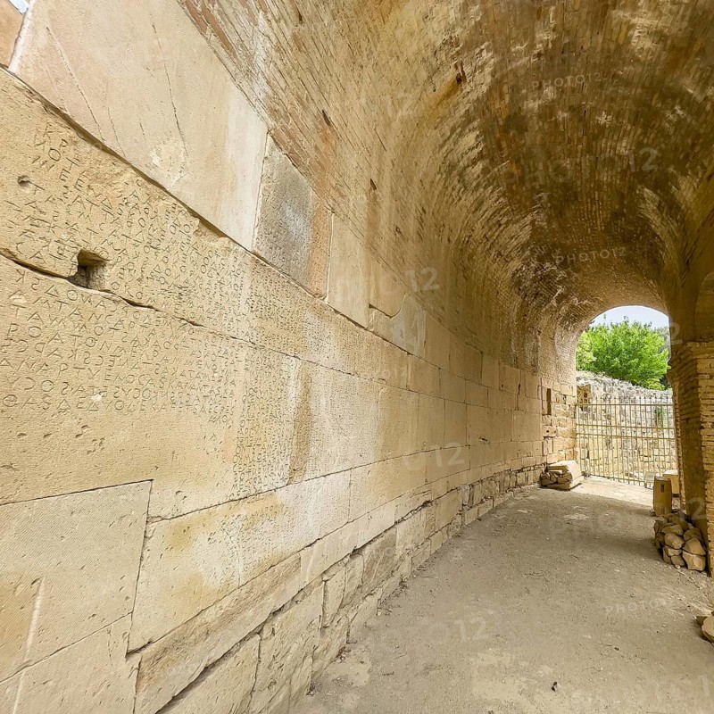 Wall of archway behind amphitheatre carved written chiselled laws City law of Gortys carved in stone Gortyn law book Large inscription, written in Doric dialect alternately from left to right and right to left, oldest discovered legal text in Europe, Gortyna, Crete, Greece, Europe