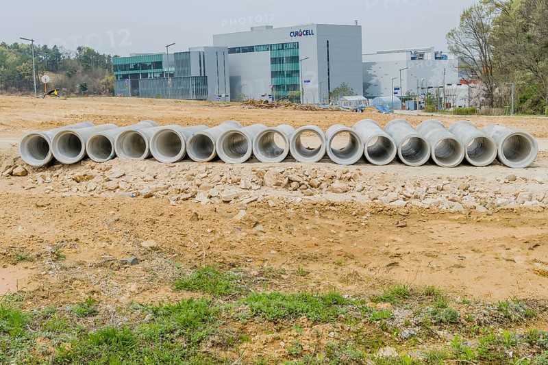Row of concrete culvert pipes on ground at construction site in Daejeon, South Korea, Asia