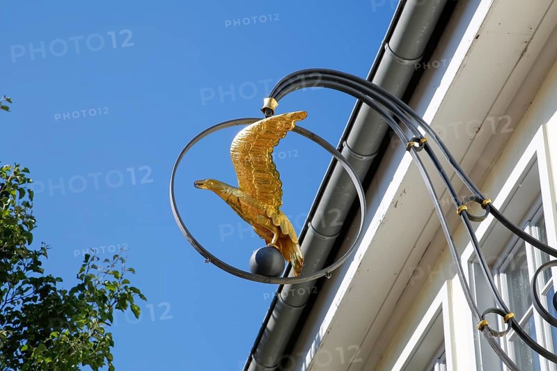 Inn sign, pub, restaurant, figure of a golden eagle, advertising sign, Hotel Adler am Schloss, nose sign, cantilever, advertising, behind building, gutter, window, Boennigheim, Ludwigsburg district, Baden-Wuerttemberg, Germany, Europe