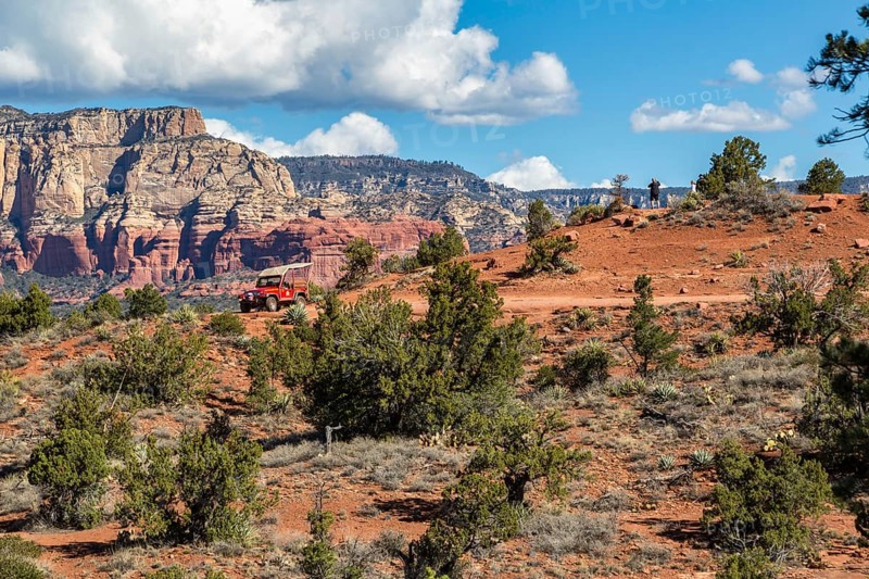 Tourists on Red Rock Jeep Tour look out over the valley in Sedona, Arizona, USA, North America