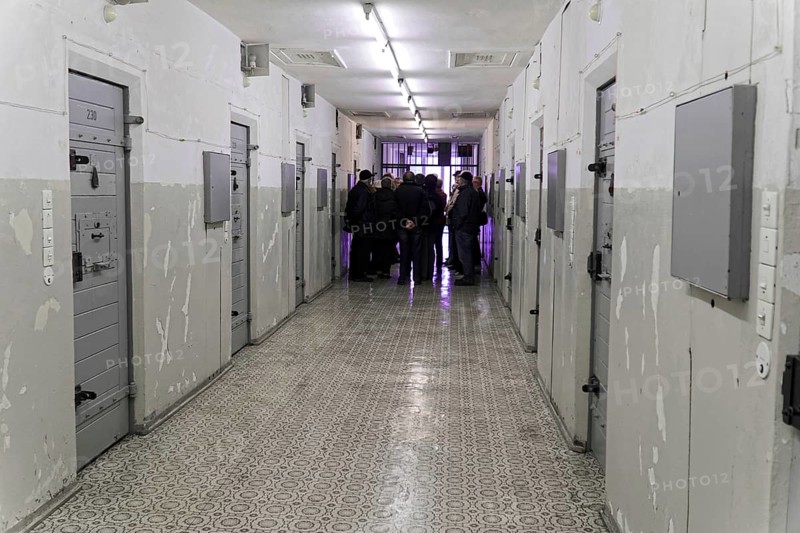 Group of people in the corridor of a prison with grey doors and neon lighting, Berlin-Hohenschoenhausen Memorial, former headquarters, Stasi remand prison, Berlin, Germany, Europe