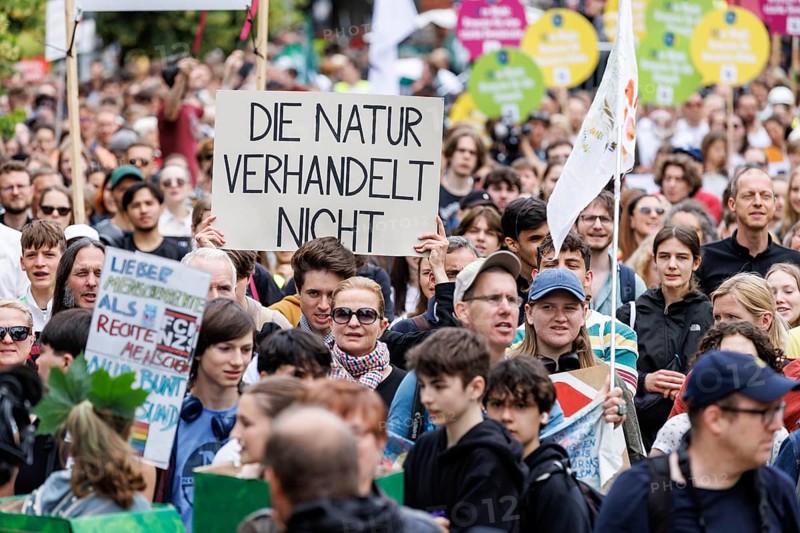 Demonstrators with signs at Fridays for Future, taken during the climate strike for the EU elections in Berlin, 31/05/2024