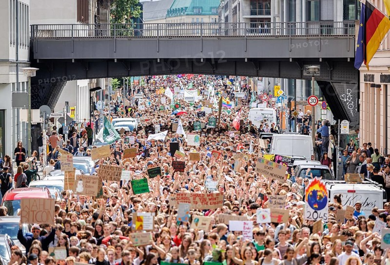 Demonstrators with signs at Fridays for Future, taken during the climate strike for the EU elections in Berlin, 31/05/2024