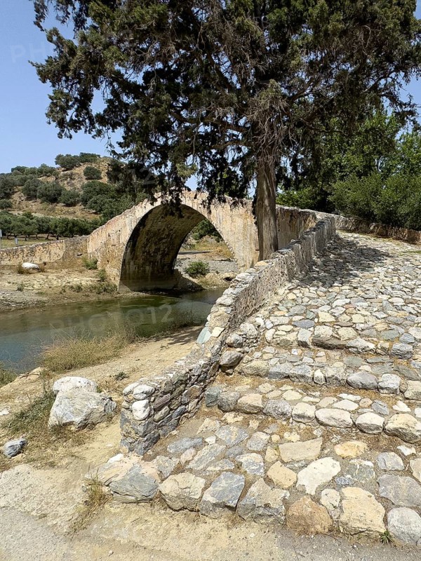 View of stairway with coarse cobblestones in the centre of the picture Steps of historic classical arched stone bridge in Venetian architectural style Venetian Great Old Bridge 19th century stone bridge built in 1850 in Ottoman times over the middle reaches of Megalopotamos River at Preveli, Agios Vasilios, Crete, Greece, Europe