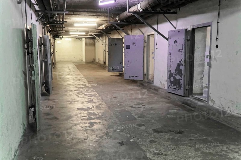 Long corridor in a prison with open metal doors and dirty walls. Cold and deserted, Berlin-Hohenschoenhausen Memorial, former headquarters, Stasi remand centre, Berlin, Germany, Europe