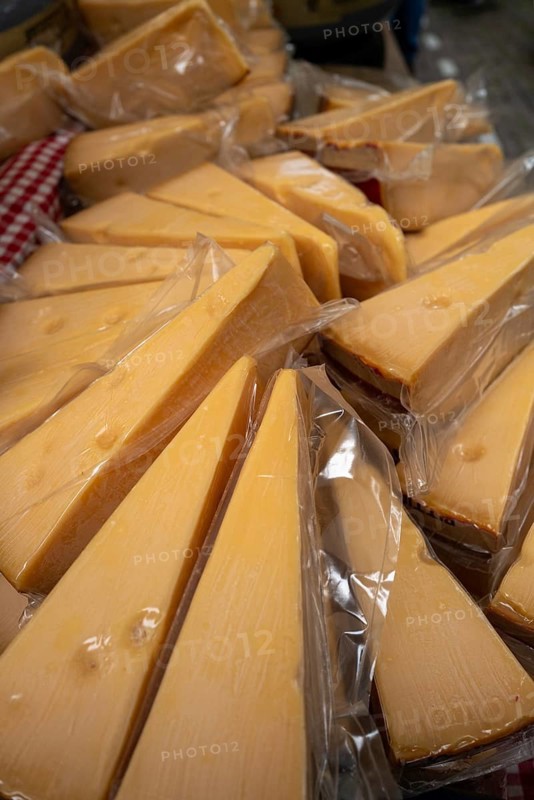 Dutch cheese on display in the town of Alkmaar on a market day., Alkmaar, The Netherlands, Europe