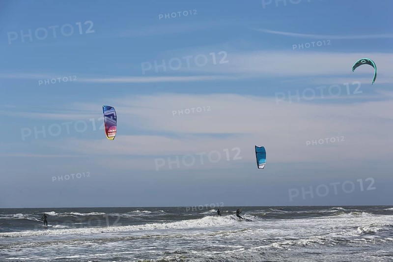 Kite surfers enjoy the waves on a glorious day along the Dutch coast. Castricum, Netherlands
