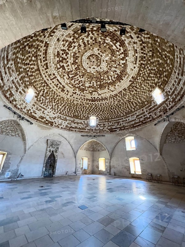 View of interior of domed building former Sultan Ibrahim Mosque with mosaic ceiling in dome built 1646 after Ottoman conquest of Crete at former site of Venetian bishop church San Nicolo in ruins fortress ruins of historic fortress Fortetza Fortezza of Rethymno built by Republic of Venice in 16th century. century in northwest of old town of Rethymno on rocky hill Paleokastro on north coast of island Crete, Rethymno, Crete, Greece, Europe