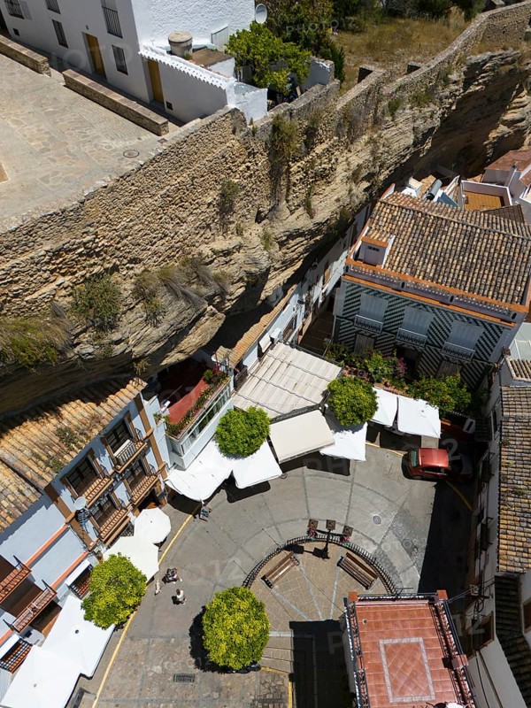 Aerial view of a Spanish village with narrow streets and stone wall, surrounded by buildings and trees in summer, aerial view, cave dwellings, Setenil de las Bodegas, Cadiz, Andalusia, Spain, Europe